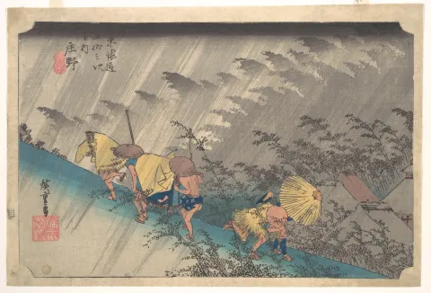 Travellers hurry up a hillside path through driving rain, rendered as diagonal woodblock lines.
