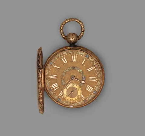 An open gold pocket watch showing its enamelled dial with roman numerals and a small subsidiary seconds dial.